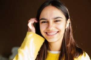 A smiling girl with metal braces.